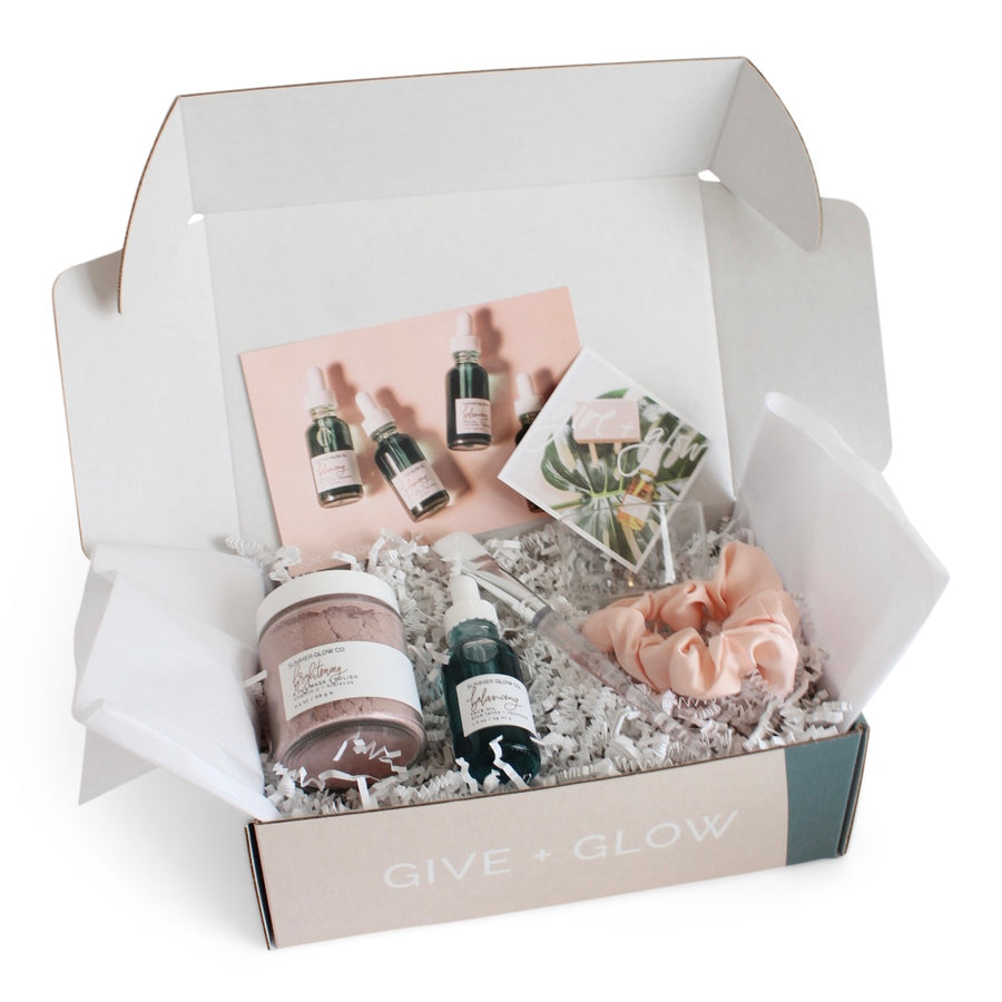 packaged gift box with face mask, oil, and hair tie