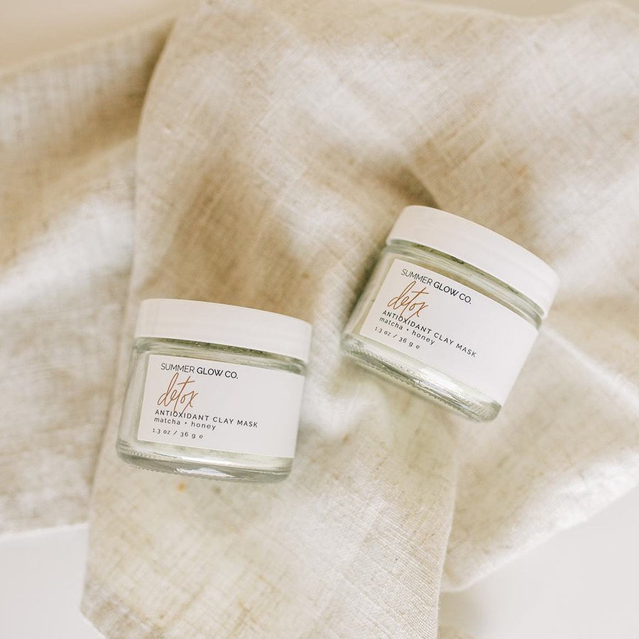 two jars of matcha face mask on linen cloth